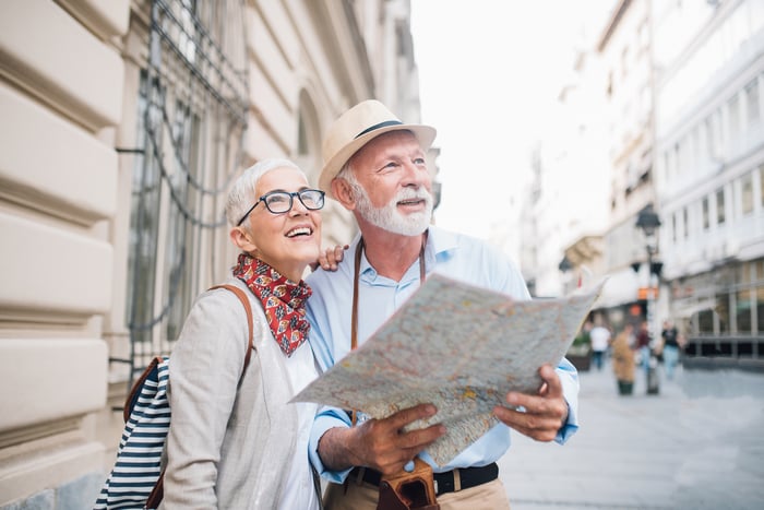 Two people outdoors holding a map.