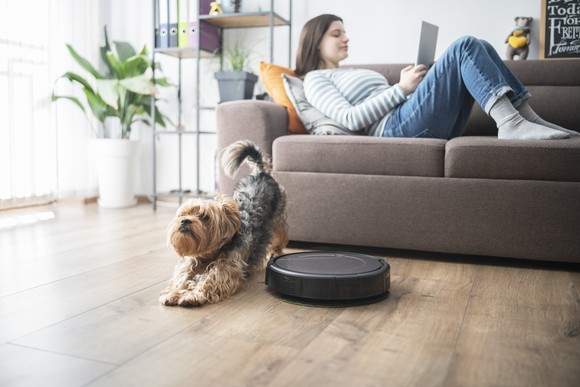 A robot vacuum cleans the floor. 