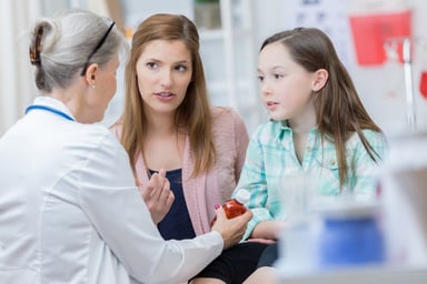 doctor talks to mother and child patient