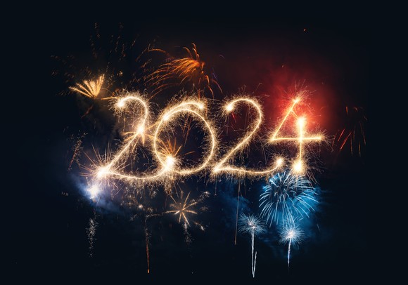 The year 2024 is written in a dark sky with gold fireworks.