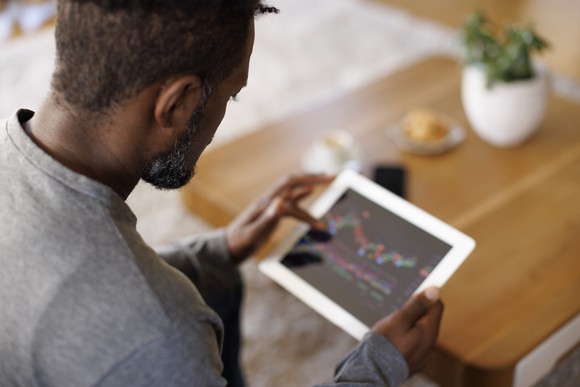 Person looking at charts on tablet.