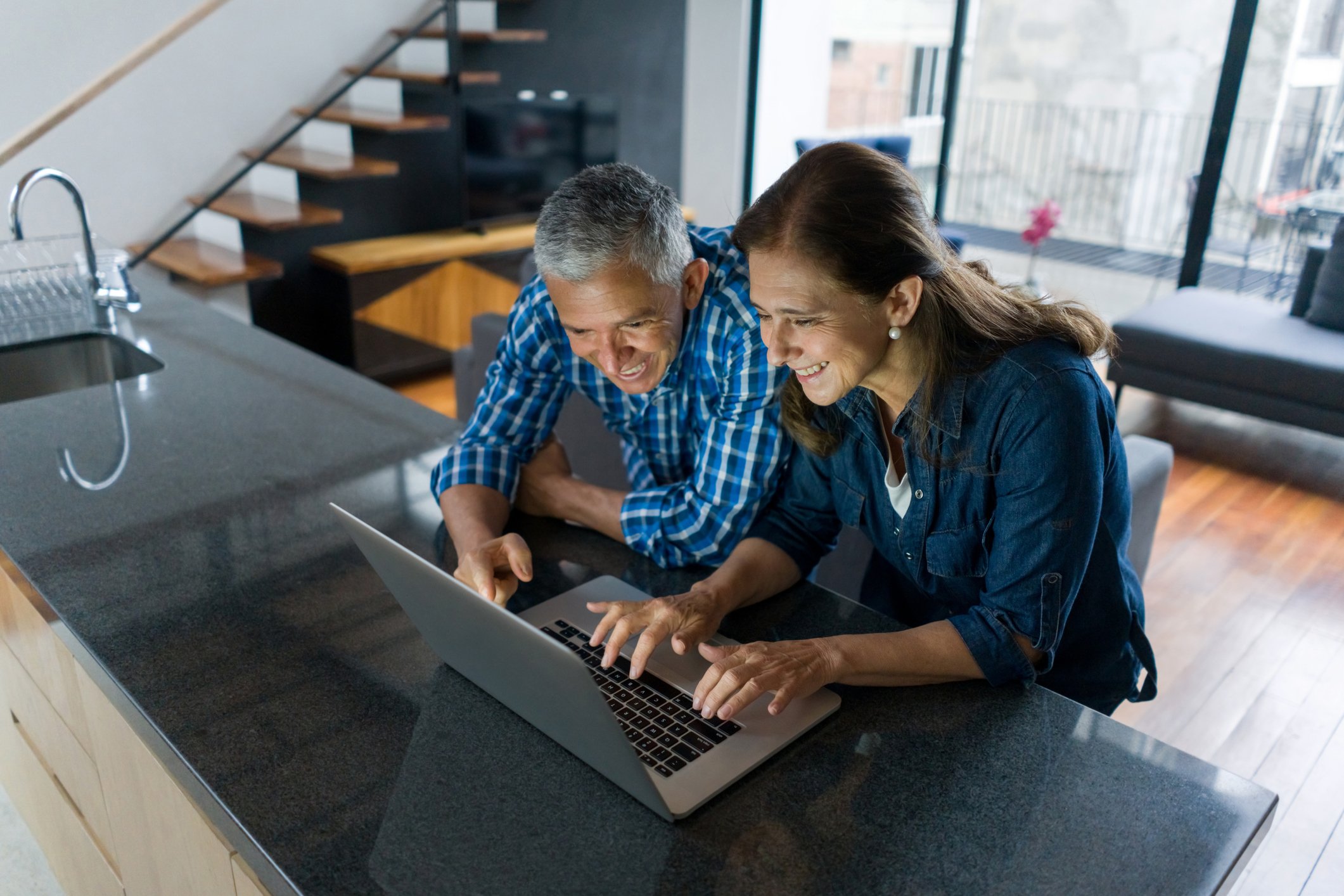 Two people looking at a laptop.