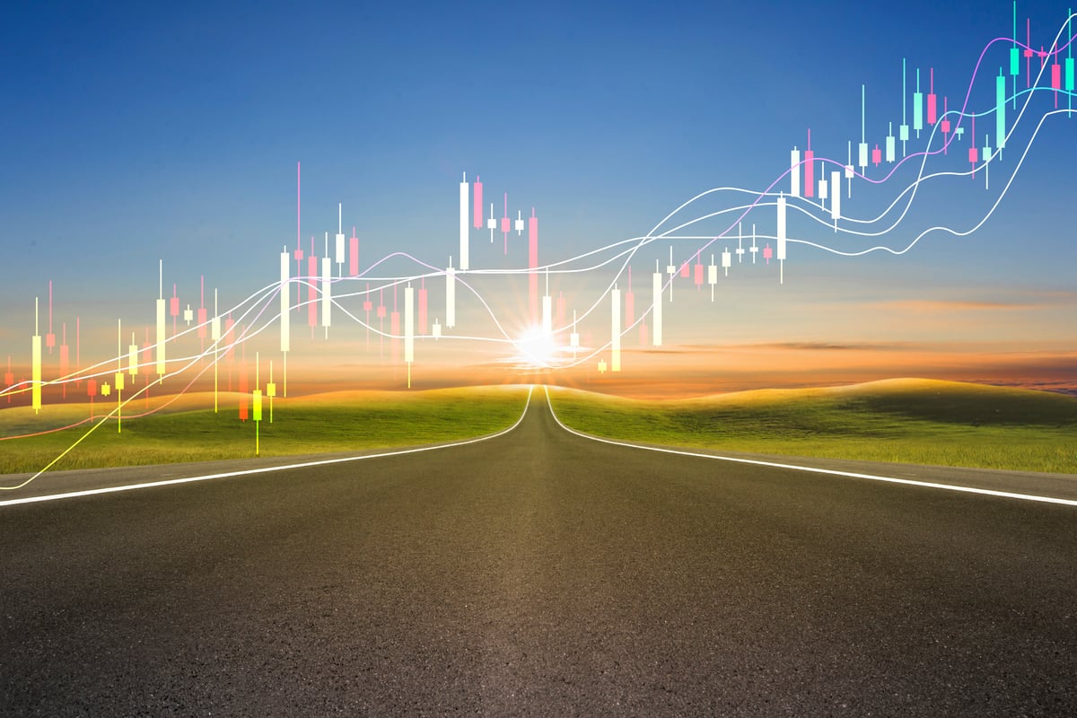 A rendering of a candle stick chart over an open road. 