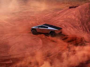 Tesla cybertruck spinning out in red dirt