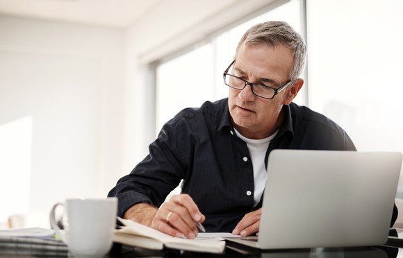 Man looking through financial information on a computer