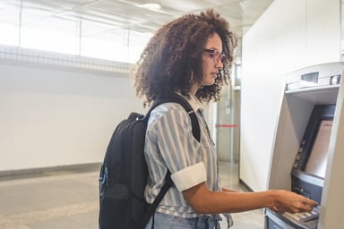 Young person using an ATM