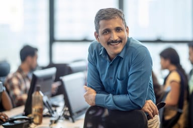 Getty - happy smiling business person at office