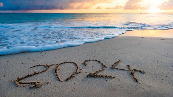 2024 written on a beach.