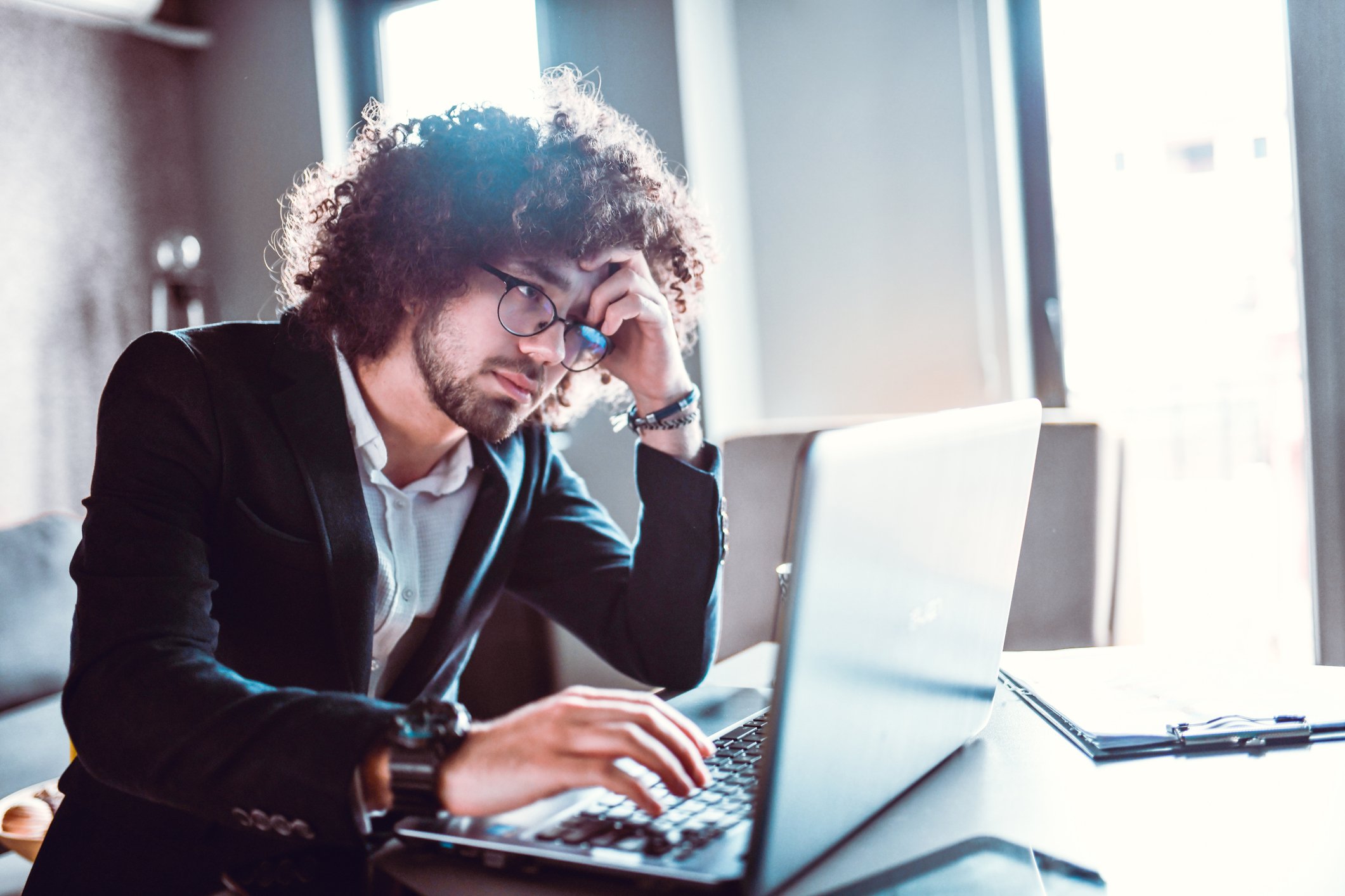 stressed investor at laptop