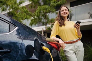 A driver waits for an electric vehicle to charge.