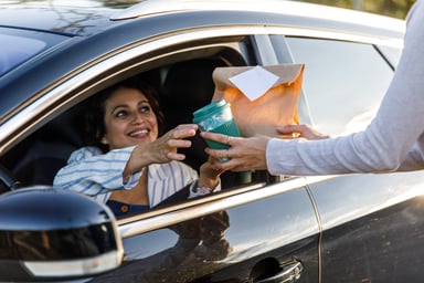 Woman getting coffee at drive thru