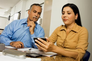 Middle-aged couple with calculator