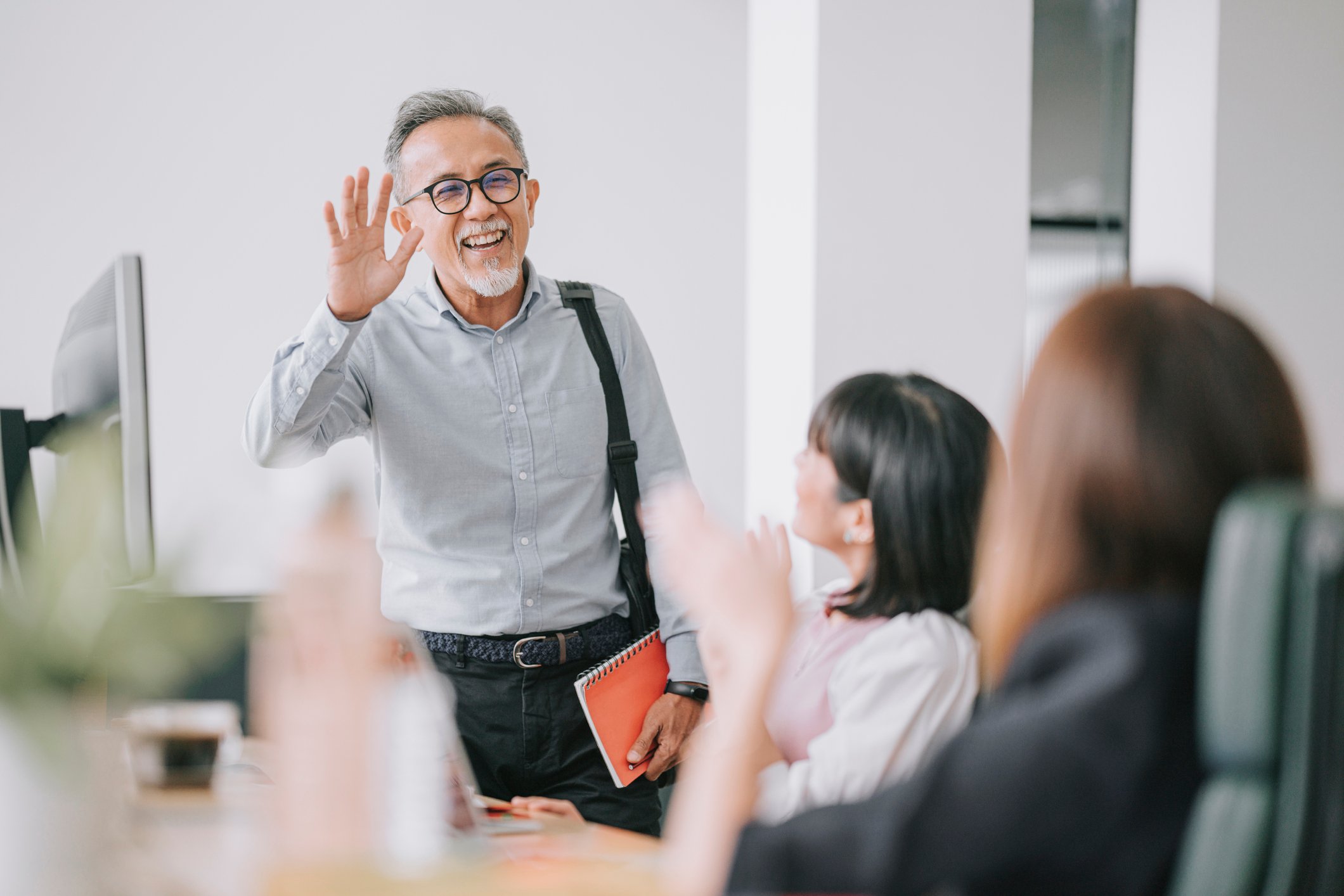 Just retired person waves goodbye to colleagues