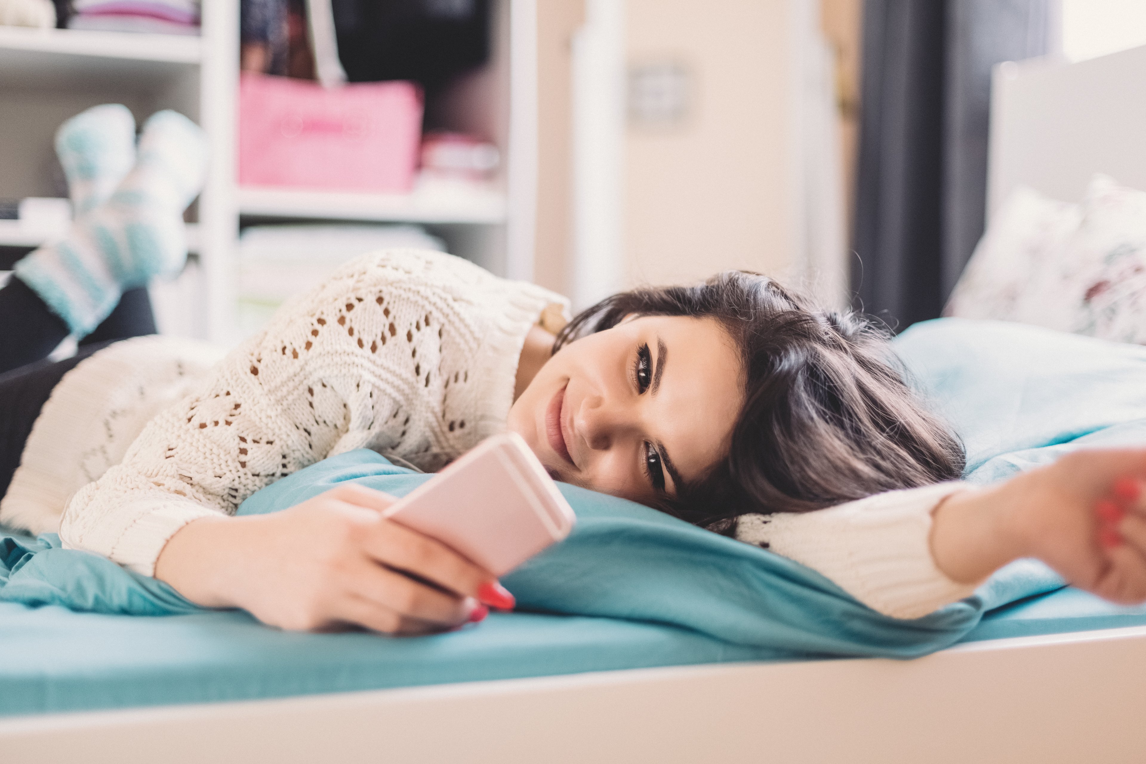 Girl smiling at smartphone