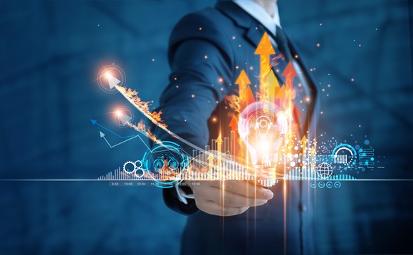 A person in a suit points to an illustration with up arrows