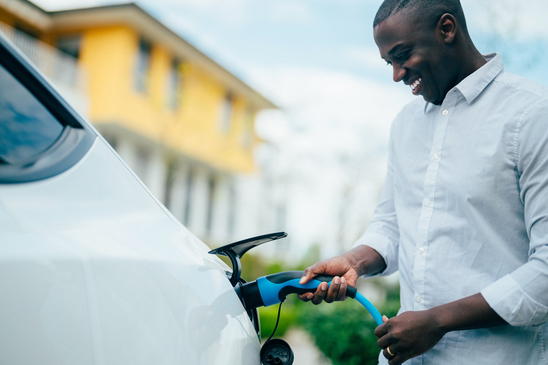 Driver charges an electric vehicle.