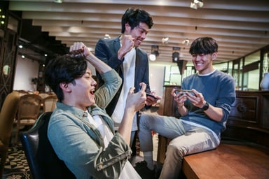 People playing video games in a cafe.