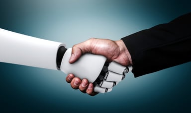 human and robot shaking hands