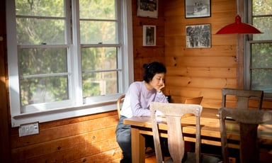 person on computer in cabin_AirBNB
