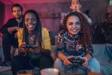 friends sitting at home, playing video games