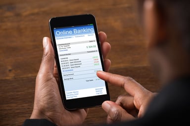 woman using cellphone for mobile online banking