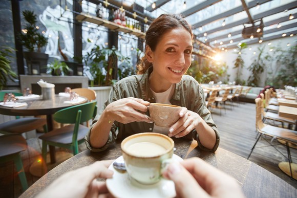 People in airy coffee shop/restaurant.