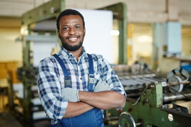 Getty - happy worker in machine shop smiling