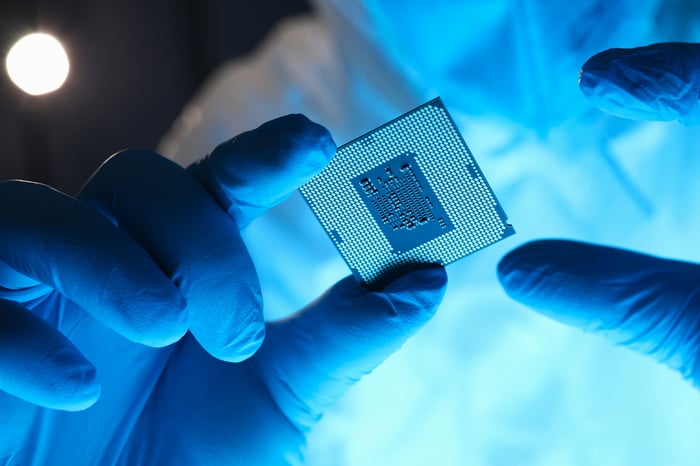 Closeup of semiconductor in technician's hands. 