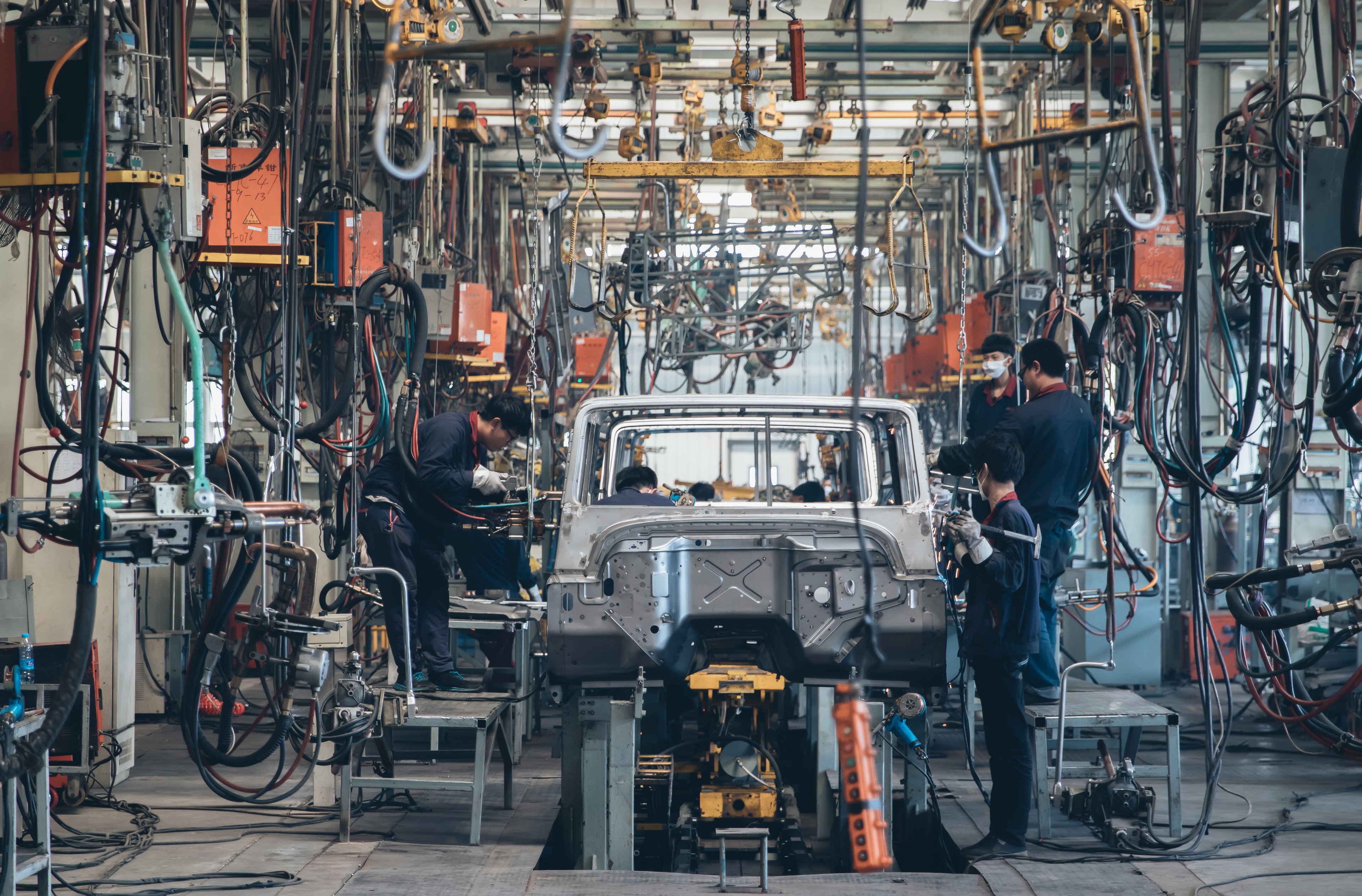 People working on a car assembly line