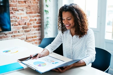 A person looks over data in a folder