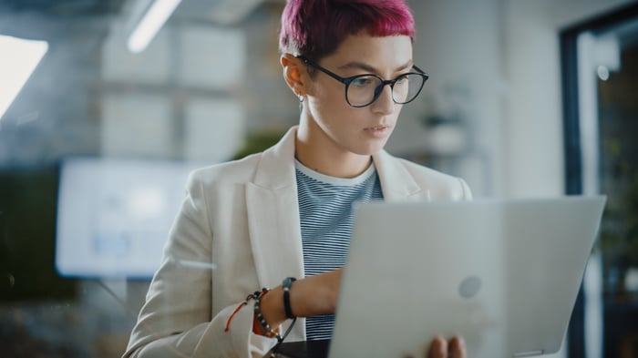 A person holding a laptop.