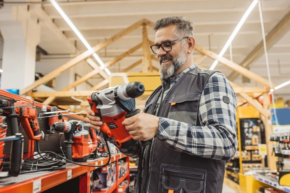 A homeowner shopping for tools in a Home Depot home improvement store.