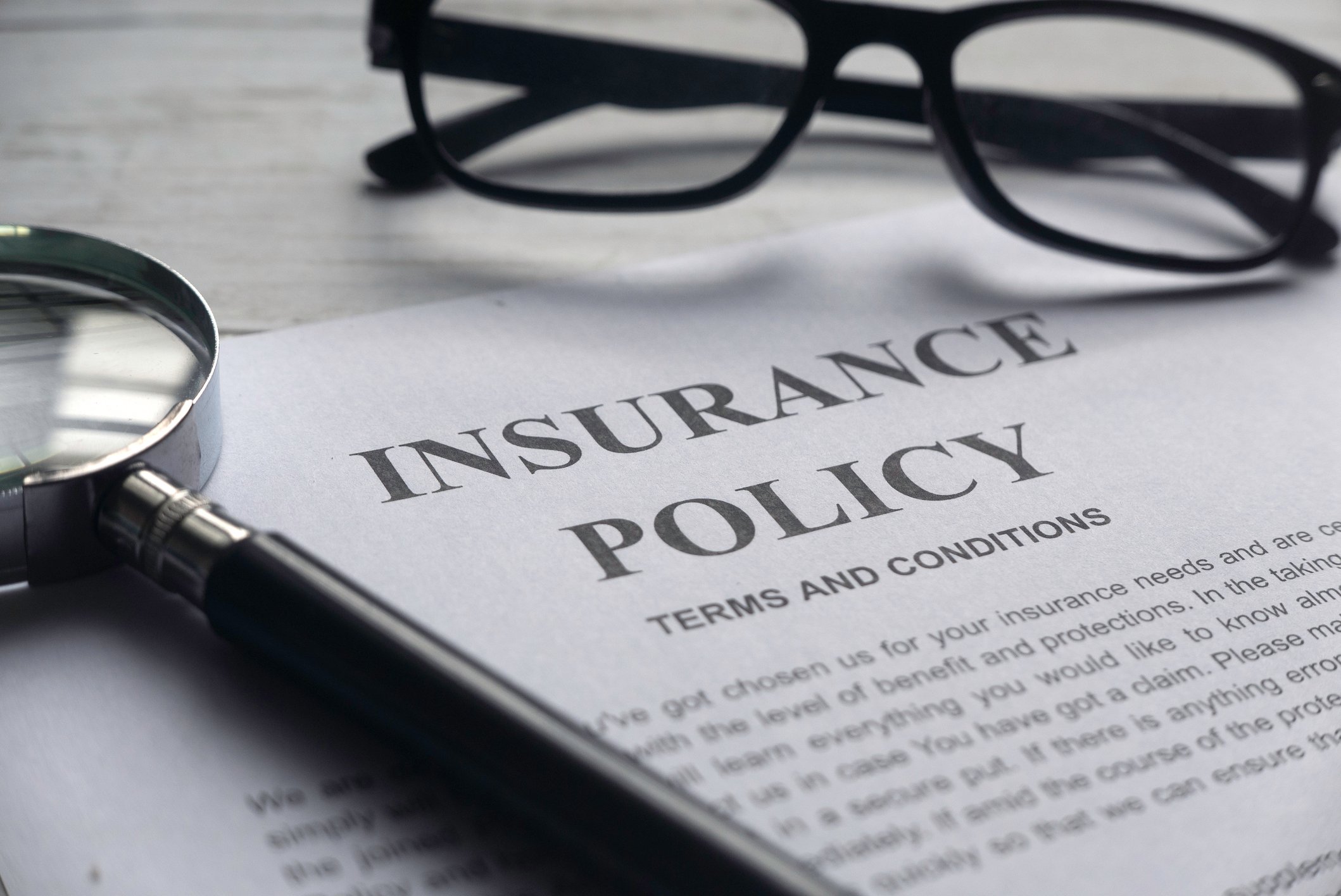 insurance policy and glasses