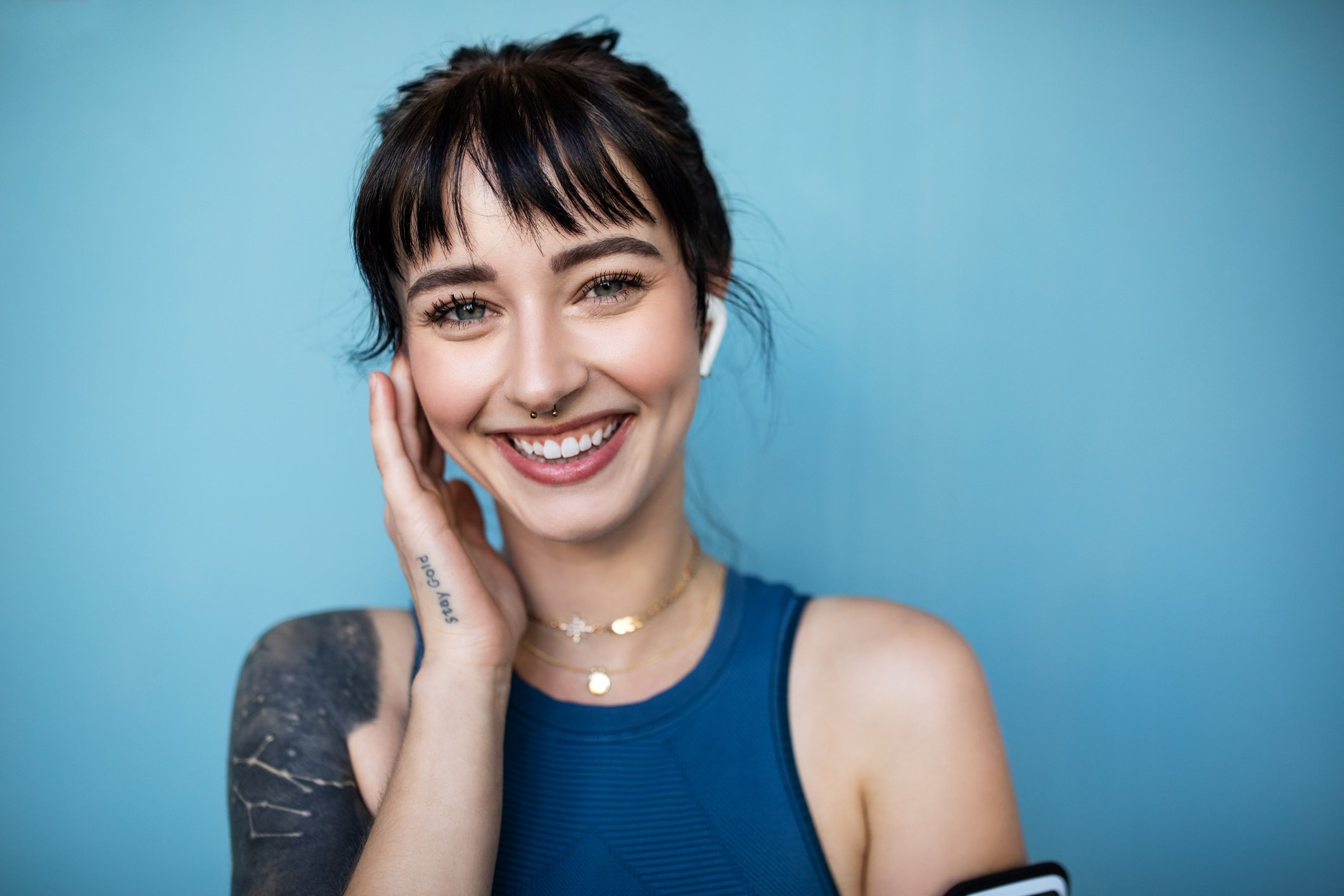 Smiling young woman wearing earbuds