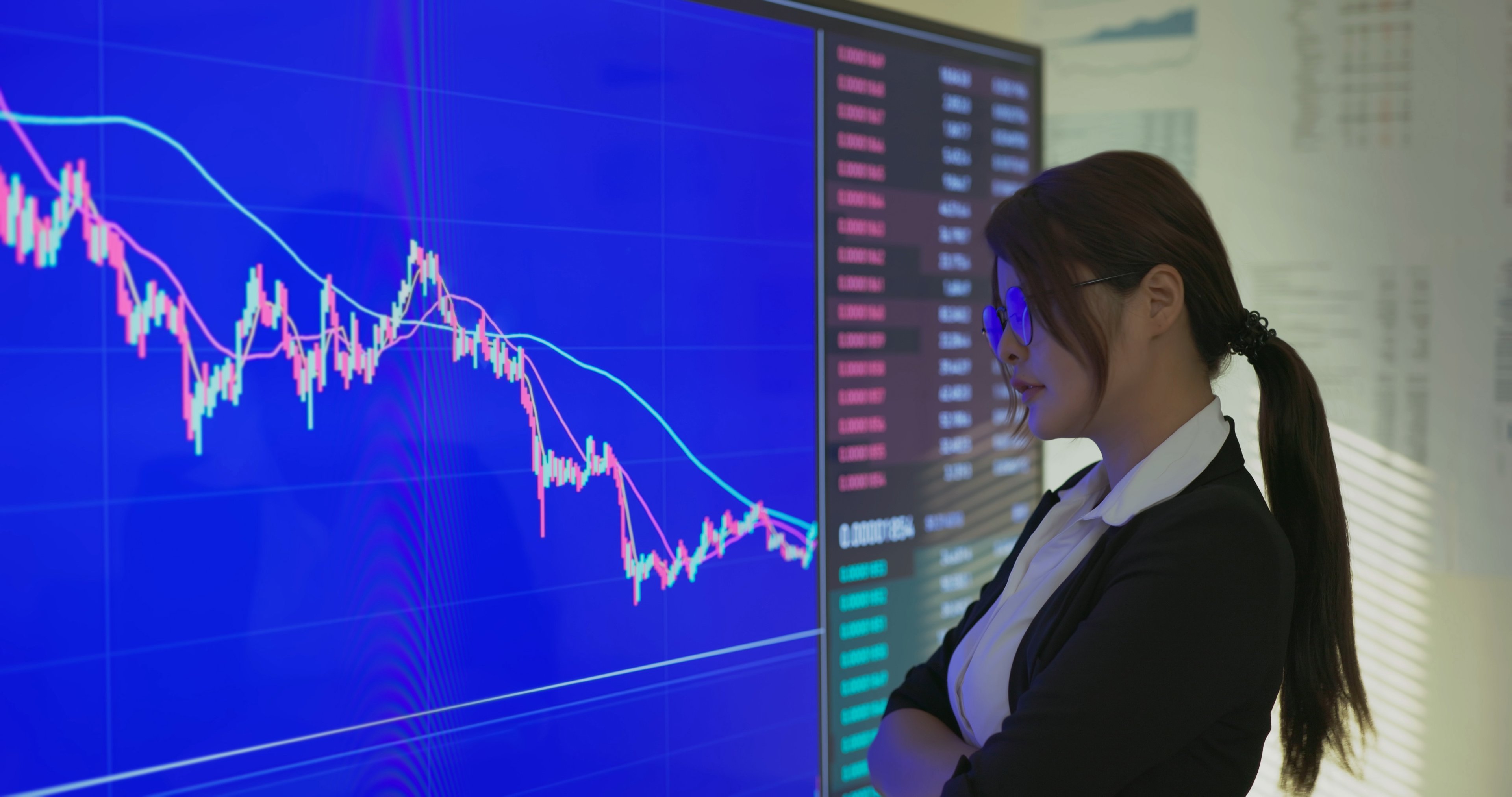 woman watching declining stock market chart