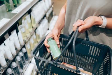 person shopping in shampoo aisle