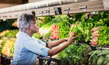 Senior woman produce aisle GettyImages-1145100470