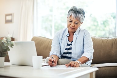 older woman laptop pen GettyImages-902863756