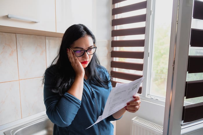 Stressed person looking at document.