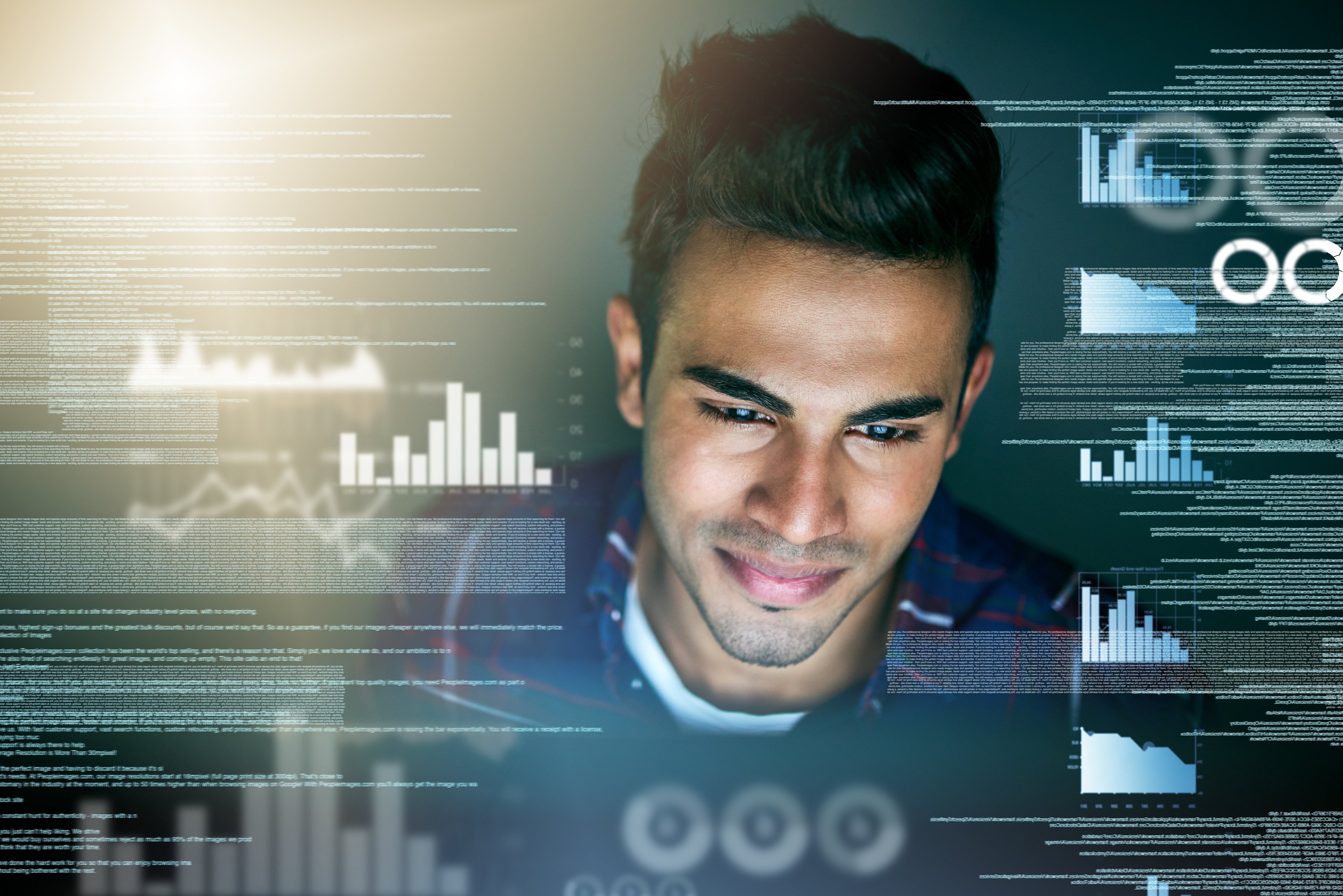 Developer looking at screen with graph icons around him. 