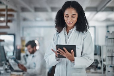 Scientist smiling holding tablet computer