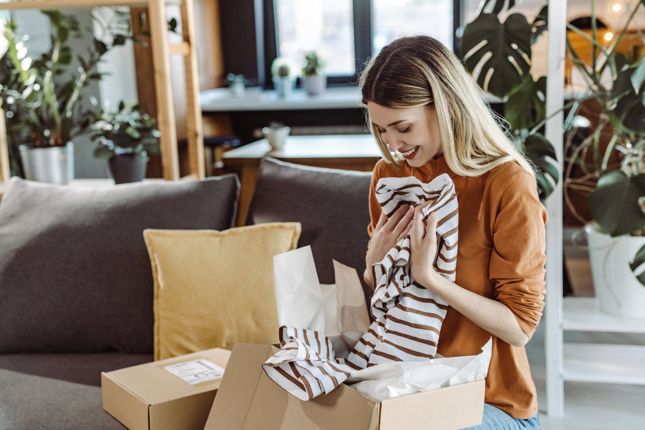 person opening box of clothes