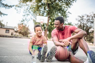 A person with a child and a basketball