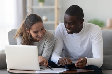 A couple reviewing a document at home.