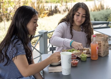 people eating Chipotle outdoors