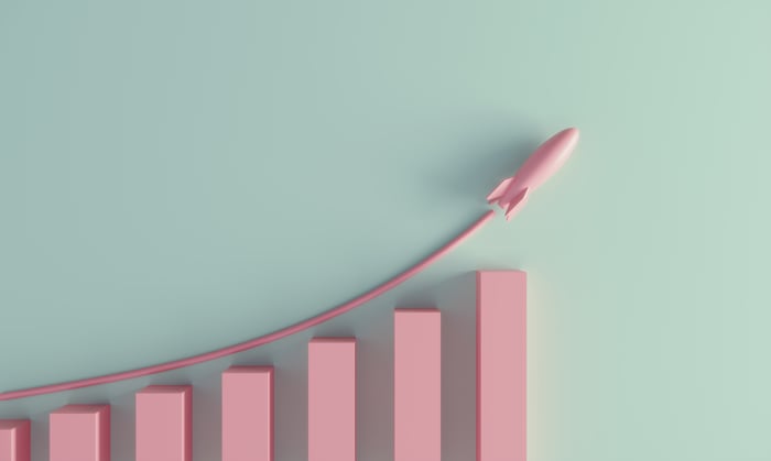 A pink model rocket trailing an ascending line above a bar graph.