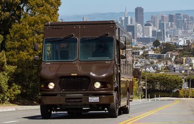 UPS truck with city in background