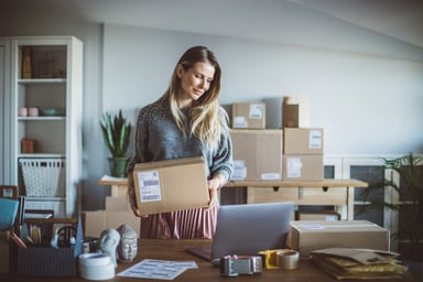 a business owner prepares packages for delivery.