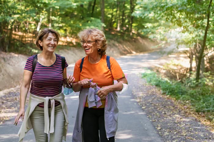 Two smiling people out for a hike.