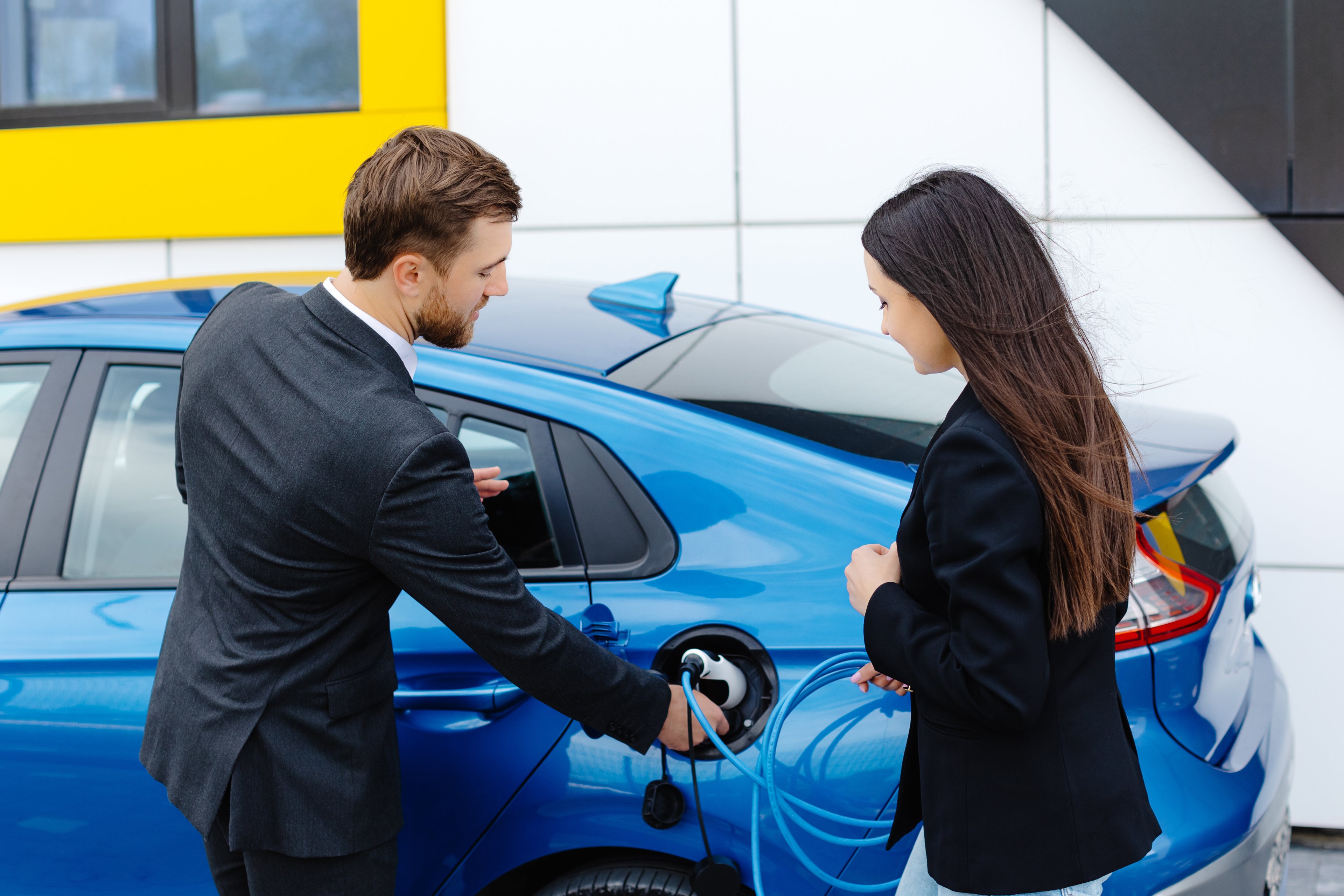 drivers charge an electric car.
